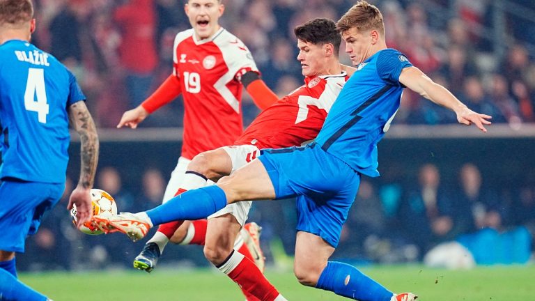 Denmark's Christian Noergaard, second from right, and Slovenia's Jaka Bijol, right, vies for the ball during the Euro 2024 second round Group H qualifying match between Denmark and Slovenia at Parken Stadium in Copenhagen, Friday Nov. 17, 2023. ((Liselotte Sabroe/Ritzau Scanpix via AP)