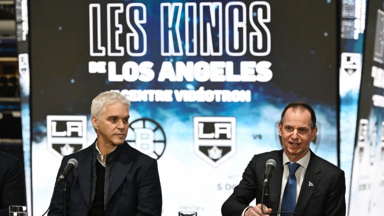 Quebec Finance Minister Eric Girard speaks at a news conference, Tuesday, November 14, 2023 at the Videotron Centre in Quebec City. The Los Angeles Kings will hold the final leg of their training camp at the Videotron Centre in Québec City from October 2 to 6, 2024, with two games against the Boston Bruins on October 3 and the Florida Panthers on October 5. Luc Robitaille, president of the L.A. King, left, looks on. (Jacques Boissinot/CP)