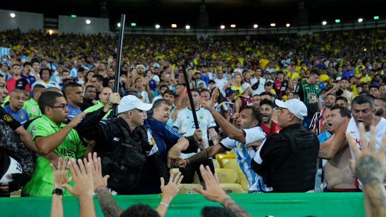 Police try to stop a fight between Brazilian and Argentinian fans that broke out prior to a qualifying soccer match for the FIFA World Cup 2026 between Brazil and Argentina at Maracana stadium in Rio de Janeiro, Brazil, Tuesday, Nov. 21, 2023. (Silvia Izquierdo/AP)