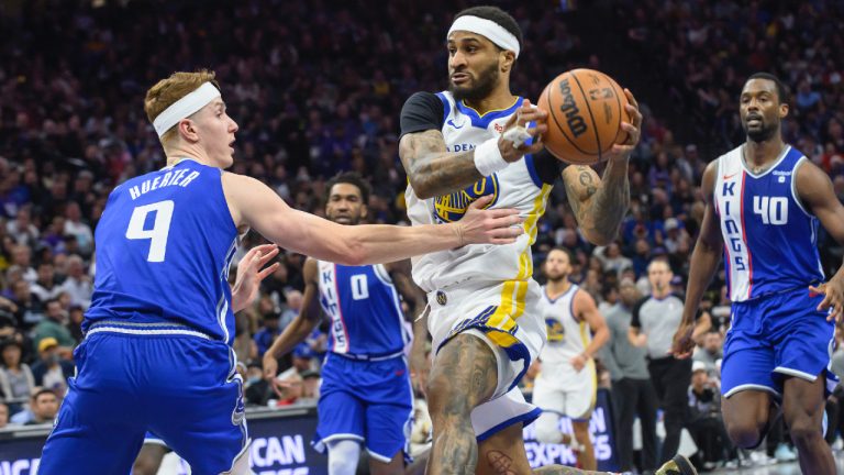 Golden State Warriors guard Gary Payton II, centre, drives to the basket past Sacramento Kings guard Kevin Huerter (9) during the second half of an NBA In-Season Tournament basketball game in Sacramento, Calif., Tuesday, Nov. 28, 2023. The Kings won 124-123. (Randall Benton/AP)