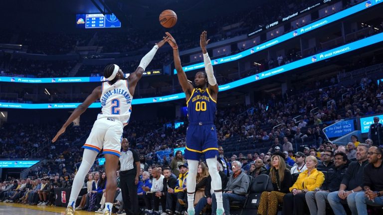 Golden State Warriors forward Jonathan Kuminga (00) shoots a 3-pointer over Oklahoma City Thunder guard Shai Gilgeous-Alexander (2) during the first half of an NBA basketball game Thursday, Nov. 16, 2023, in San Francisco. (Loren Elliott/AP)