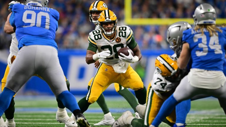 Green Bay Packers running back AJ Dillon (28) looks for a gap during the second half of an NFL football game against the Detroit Lions, Thursday, Nov. 23, 2023, in Detroit. (David Dermer/AP)