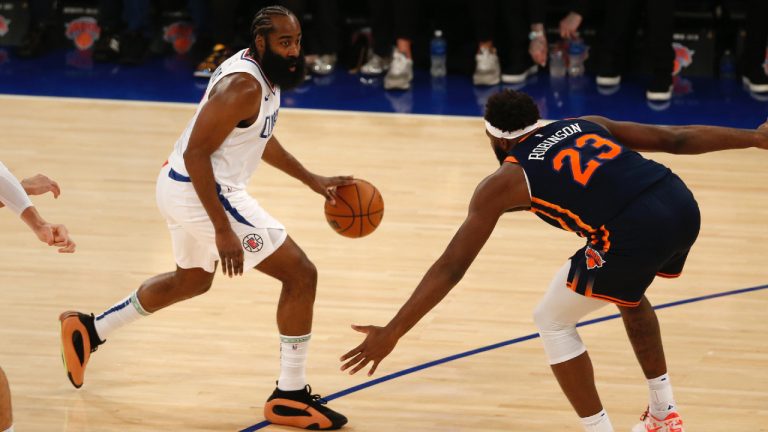 Los Angeles Clippers guard James Harden is defended by New York Knicks center Mitchell Robinson (23) during the first half of an NBA basketball game, Monday, Nov. 6, 2023, in New York. (John Munson/AP)