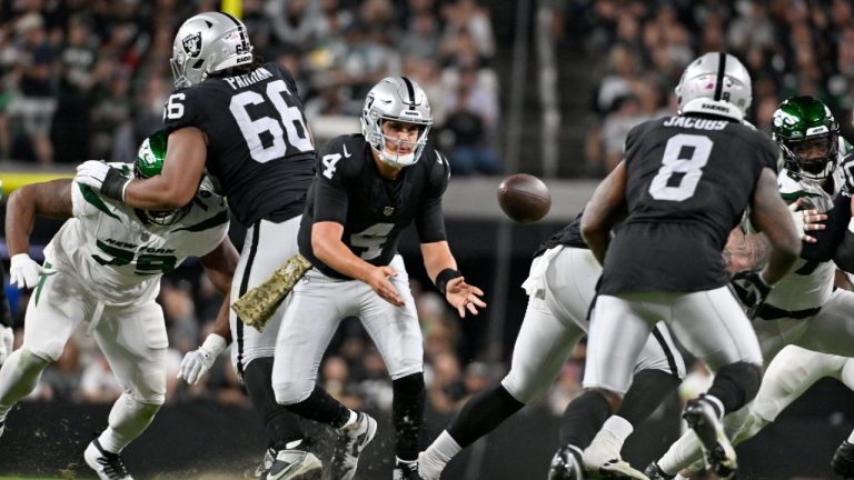 Las Vegas Raiders quarterback Aidan O'Connell (4) tosses to running back Josh Jacobs (8) during the first half of an NFL football game against the New York Jets Sunday, Nov. 12, 2023, in Las Vegas. (David Becker/AP)