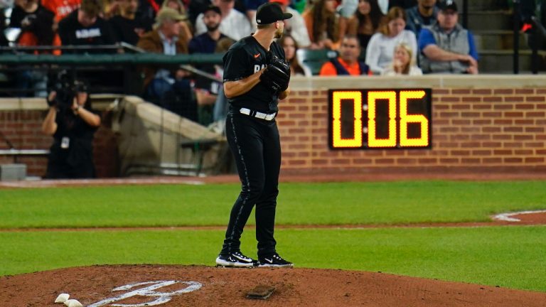 The pitch clock is visible as Baltimore Orioles relief pitcher Austin Voth prepares to throw a pitch during the sixth inning of a baseball game between the Baltimore Orioles and the Texas Rangers, Friday, May 26, 2023, in Baltimore. (Julio Cortez/AP)