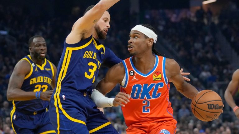 Oklahoma City Thunder guard Shai Gilgeous-Alexander (2) drives to the basket against Golden State Warriors guard Stephen Curry during the first half of an NBA basketball game in San Francisco, Tuesday, April 4, 2023. (Jeff Chiu/AP)