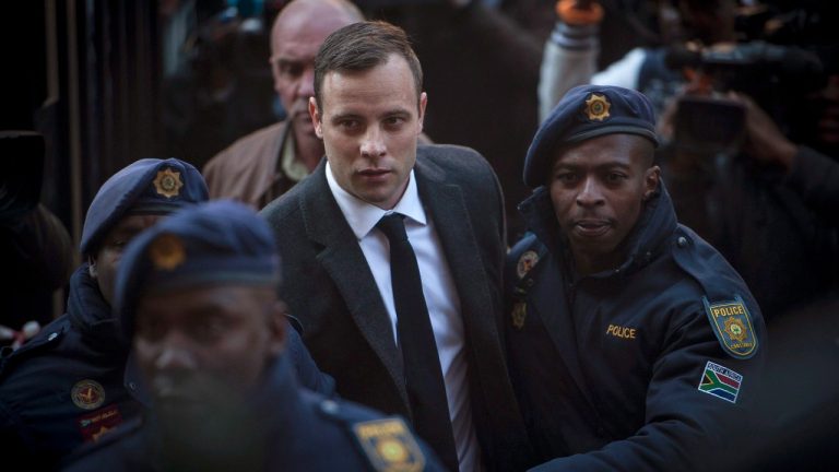 In this July 6 2016 file photo Oscar Pistorius, center, arrives at the High Court in Pretoria, South Africa where he was sentenced to six years for the the killing of his girlfriend Reeve Steenkamp. (Shiraaz Mohamed/AP)