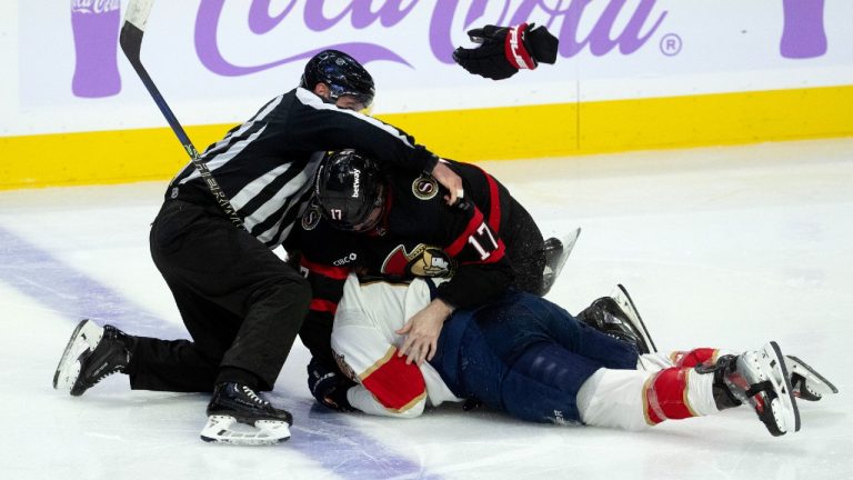 The linesman tries to pull Ottawa Senators centre Zack MacEwen and Florida Panthers left wing Matthew Tkachuk apart during third period NHL action, in Ottawa, Monday, Nov. 27, 2023. (Adrian Wyld/CP)