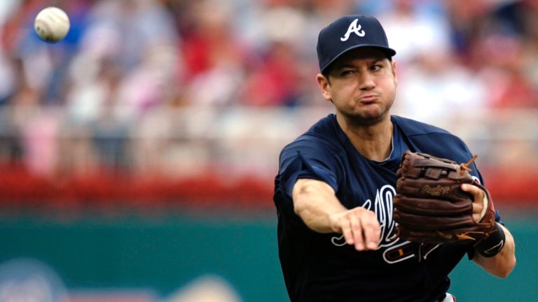 Former Atlanta Braves shortstop Paul Janish makes a throw to first base after fielding a ground ball during their baseball game against the Washington Braves in Washington, Sunday, July 22, 2012. (Cliff Owen/AP)