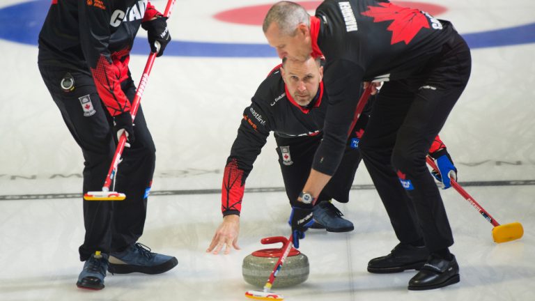 Team Canada skip Brad Gushue makes a shot as lead Geoff Walker, left, and second E.J. Harnden sweep as they take on Taiwan at the Pan Continental Curling Championship in Kelowna, B.C. in this Wednesday, Nov. 1, 2023 handout photo. (CP/HO, Curling Canada, Michael Burns)