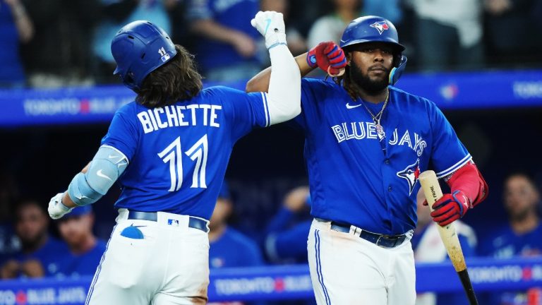 Toronto Blue Jays shortstop Bo Bichette (11) celebrates his solo home run against the Detroit Tigers with teammate Vladimir Guerrero Jr. (27) during eighth inning MLB American League baseball action in Toronto on Tuesday, April 11, 2023. (Nathan Denette/CP)