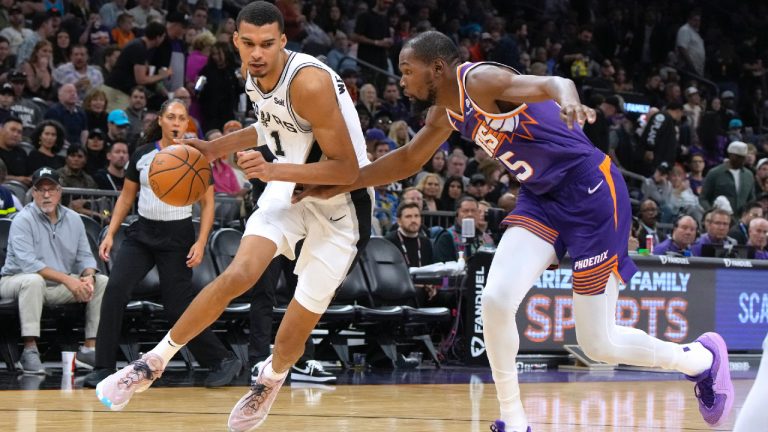 San Antonio Spurs centre Victor Wembanyama (1) drives on Phoenix Suns forward Kevin Durant during the second half of an NBA basketball game Thursday, Nov 2, 2023, in Phoenix. (Rick Scuteri/AP)