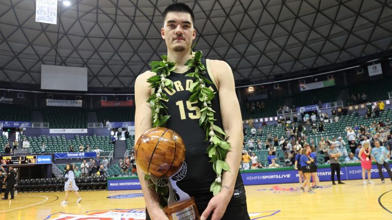 Purdue center Zach Edey (15) holds the MVP award after an NCAA college basketball game, Wednesday, Nov. 22, 2023, in Honolulu. (Marco Garcia/AP Photo)