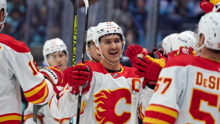 Calgary Flames center Mikael Backlund (11) celebrates his goal against the Seattle Kraken during the third period of an NHL hockey game Saturday, Nov. 4, 2023, in Seattle. (John Froschauer/AP)