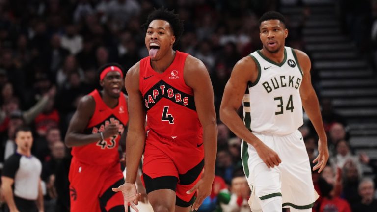 Toronto Raptors forward Scottie Barnes (4) celebrates a basket as Milwaukee Bucks forward Giannis Antetokounmpo (34) looks on during first half NBA basketball action in Toronto on Wednesday, November 1, 2023. (Nathan Denette/THE CANADIAN PRESS)