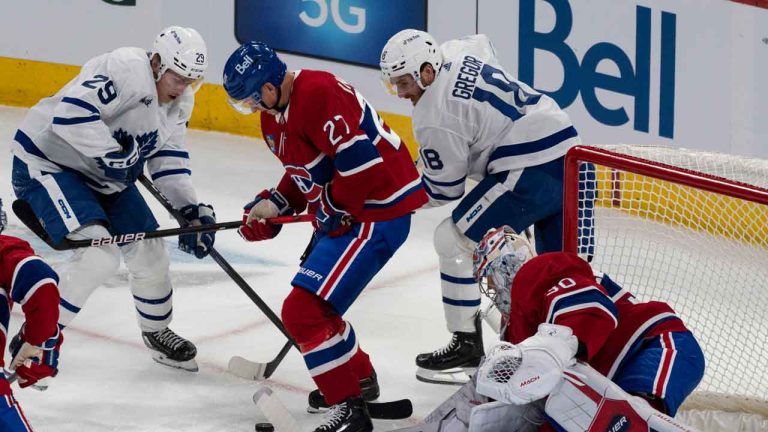 Montreal Canadiens' Cayden Primeau (30) keeps an eye on the puck against Toronto Maple Leafs' Pontus Holmberg (29) and his teammate Noah Gregor (18) as Montreal's Gustav Lindstrom (27) defends during first period NHL preseason hockey action. (Christinne Muschi/THE CANADIAN PRESS)