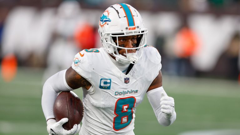 Miami Dolphins safety Jevon Holland (8) runs an interception back for a touchdown against the New York Jets during the second quarter of an NFL football game, Friday, Nov. 24, 2023, in East Rutherford, N.J. (Noah K. Murray/AP Photo)