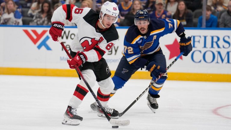 New Jersey Devils' Jack Hughes (86) handles the puck as St. Louis Blues' Justin Faulk (72) defends during the first period of an NHL hockey game Friday, Nov. 3, 2023, in St. Louis. (Jeff Roberson/AP)