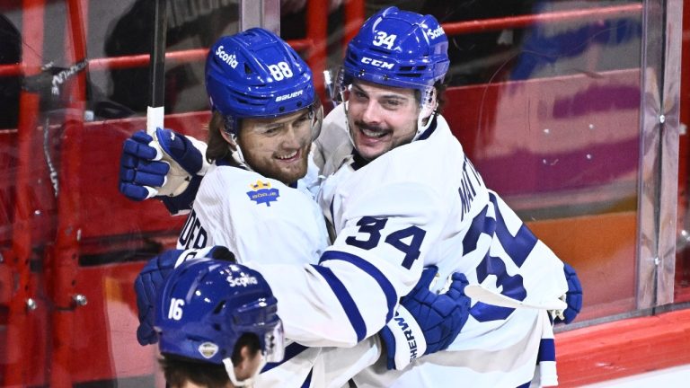 Toronto's Auston Matthews, centre, celebrates scoring with teammate William Nylander during the NHL Global Series Sweden ice hockey match between Toronto Maple Leafs and Minnesota Wild at Avicii Arena in Stockholm, Sweden, Sunday, Nov. 19, 2023.(Claudio Bresciani/TT via AP)