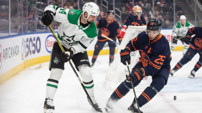 Dallas Stars' Jamie Benn (14) and Edmonton Oilers' Darnell Nurse (25) battle for the puck during first period NHL action in Edmonton on Thursday November 2, 2023. (Jason Franson/THE CANADIAN PRESS)