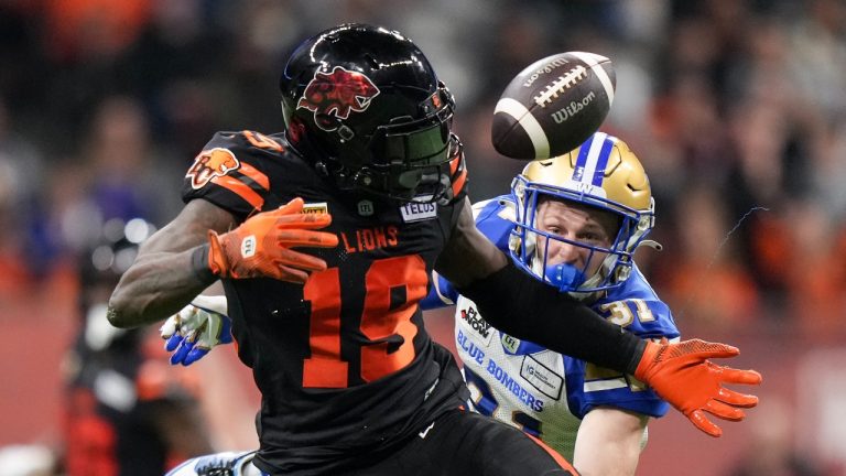 B.C. Lions' Dominique Rhymes, front left, makes a reception as Winnipeg Blue Bombers' Evan Holm defends during the second half of a CFL football game, in Vancouver, on Friday, October 6, 2023. (Darryl Dyck/THE CANADIAN PRESS)