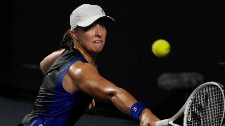 Iga Swiatek, of Poland, returns a shot to Aryna Sabalenka, of Belarus, during a women's singles semifinal match at the WTA Finals tennis championships, in Cancun , Mexico, Sunday, Nov. 5, 2023. (Fernando Llano/AP)