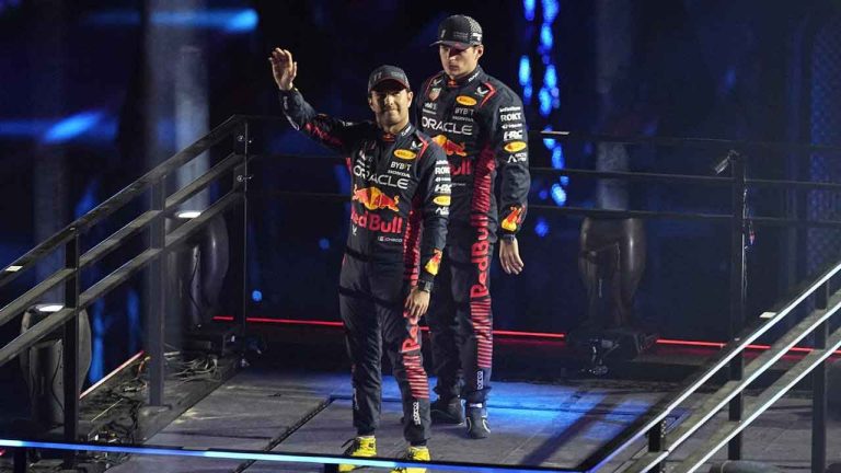 Red Bull driver Sergio Perez, of Mexico, left, and Red Bull driver Max Verstappen, of the Netherlands, motion during an opening ceremony for the Formula One Las Vegas Grand Prix auto race. (Darron Cummings/AP)
