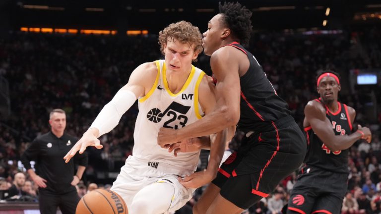 Utah Jazz forward Lauri Markkanen (23) drives at Toronto Raptors forward Scottie Barnes (4) during first half NBA basketball action in Toronto on Saturday, December 23, 2023. (Chris Young/CP)