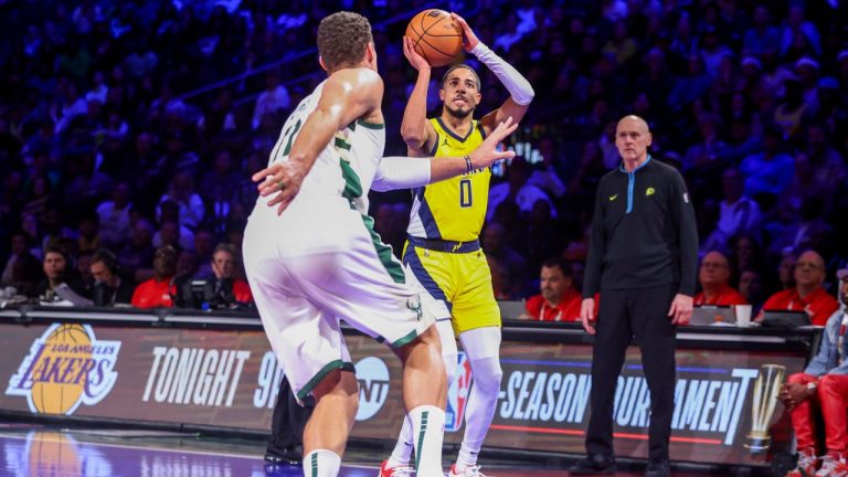 Indiana Pacers guard Tyrese Haliburton (0) lines up a shot as Milwaukee Bucks center Brook Lopez (11) defends during the second half of a semifinal in the NBA basketball In-Season Tournament, Thursday, Dec. 7, 2023, in Las Vegas. (AP Photo/Ian Maule)