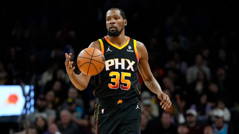 Phoenix Suns forward Kevin Durant (35) moves the ball up court against the Denver Nuggets during the first half of an NBA basketball game, Friday, Dec. 1, 2023, in Phoenix. (Matt York/AP)