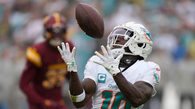 Miami Dolphins wide receiver Tyreek Hill (10) catches a touchdown pass during the first half of an NFL football game against the Washington Commanders Sunday, Dec. 3, 2023, in Landover, Md. (Mark Schiefelbein/AP)