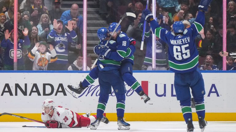 Carolina Hurricanes' Sebastian Aho lies on the ice during the third period after a Canucks goal in Vancouver, on Saturday, December 9, 2023. (Darryl Dyck/CP)