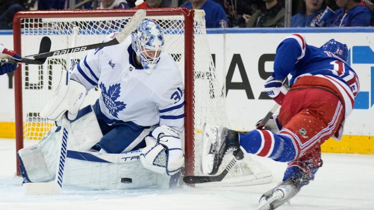 New York Rangers' Vincent Trocheck, right, falls as he takes on shot on Toronto Maple Leafs goaltender Martin Jones during the third period of an NHL hockey game, Tuesday, Dec. 12, 2023, in New York. (Seth Wenig/AP) 