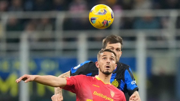 Lecce's Remi Oudin, left, and Inter Milan's Francesco Acerbi challenge for the ball during the Serie A soccer match between Inter Milan and Lecce at the San Siro stadium in Milan, Italy, Saturday, Dec. 23, 2023. (AP)