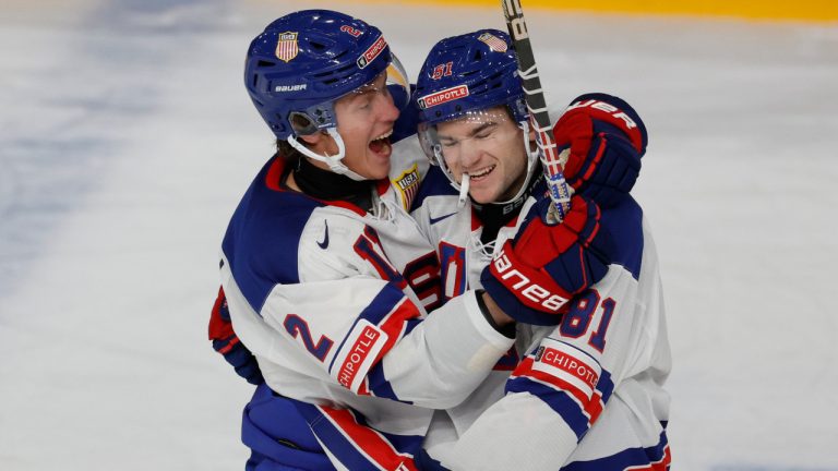 USA's Jimmy Snuggerud, right, celebrates scoring with teammate Rutger McGroarty during the group B ice hockey match between Switzerland and USA at the IIHF World Junior Hockey Championship in Gothenburg, Sweden on Thursday, Dec. 28, 2023. (Adam Ihse/TT via AP) 