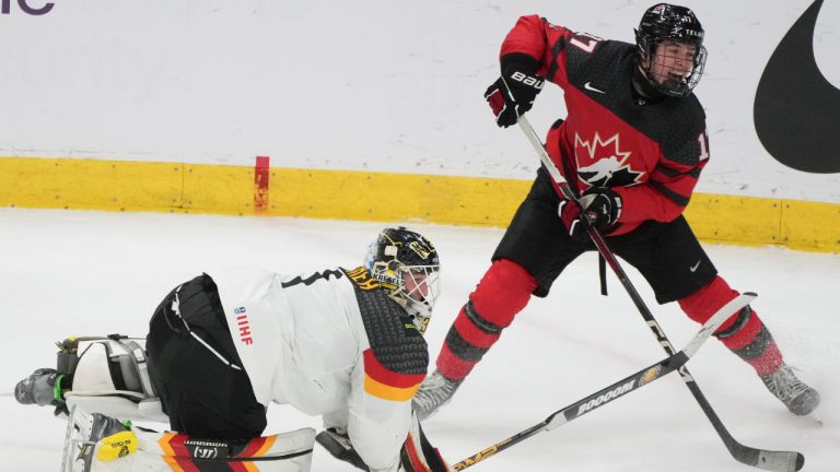 Canada's Macklin Celebrini (17) scores on Germany's Matthias Bittner (1) as he comes out of the crease during third period hockey action at the IIHF World Junior Hockey Championship in Gothenburg, Sweden, Sunday, Dec. 31, 2023. (Christinne Muschi/CP)