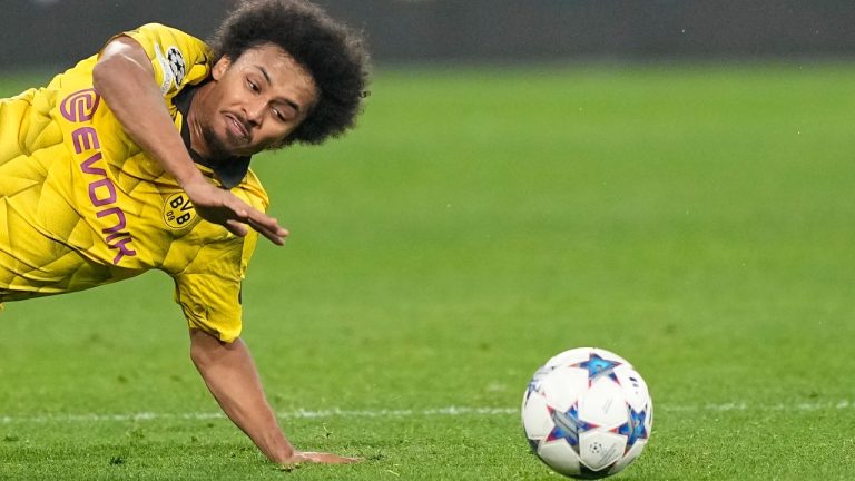 Dortmund's Karim Adeyemi challenges for the ball during the Champions League Group F soccer match between Borussia Dortmund and Paris Saint-Germain at the Signal Iduna Park in Dortmund, Germany, Wednesday, Dec. 13, 2023. (AP Photo/Martin Meissner)