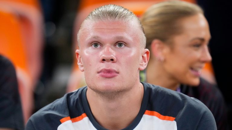 Manchester City's Erling Haaland, siting on the stands, watches the Soccer Club World Cup semifinal soccer match between Urawa Reds and Manchester City FC at King Abdullah Sports City Stadium in Jeddah, Saudi Arabia, Tuesday, Dec. 19, 2023. (AP Photo/Manu Fernandez)