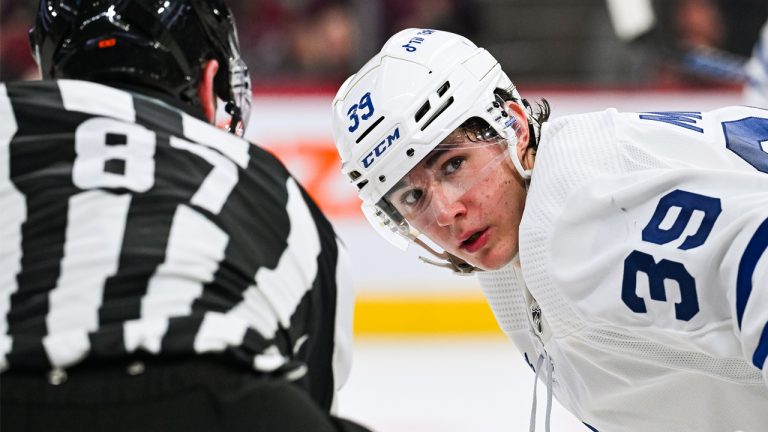 Maple Leafs prospect Fraser Minten readies for a faceoff during a preseason game against the Montreal Canadiens in late Sept. 2023. (Photo by David Kirouac/Icon Sportswire via Getty Images)