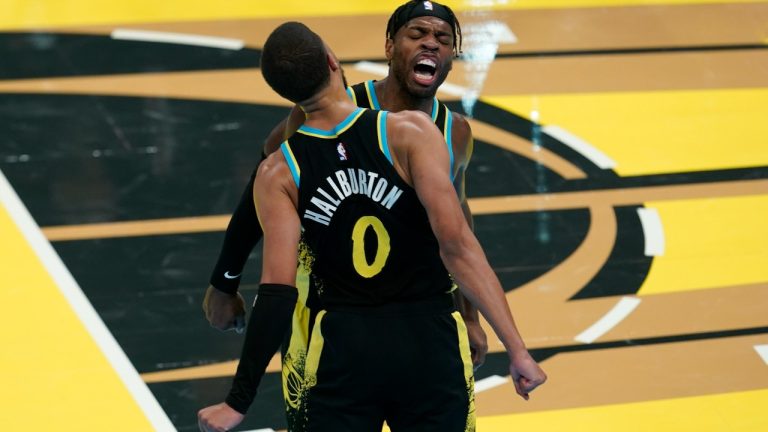 Indiana Pacers' Tyrese Haliburton (0) and Buddy Hield, right, celebrate during the second half of an NBA basketball In-Season Tournament game against the Boston Celtics, Monday, Dec. 4, 2023, in Indianapolis. (Darron Cummings/CP)