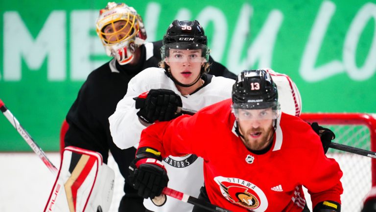 Ottawa Senators' goalie Anton Forsberg (31) peers over Jorian Donovan (56) and Jiri Smejkal (13) during the Ottawa Senators training camp in Ottawa on Thursday, Sept. 21, 2023. (Sean Kilpatrick/CP)