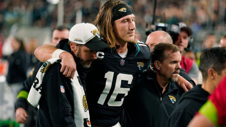 Jacksonville Jaguars quarterback Trevor Lawrence (16) is assisted off the field after he was injured during the second half of an NFL football game against the Cincinnati Bengals, Monday, Dec. 4, 2023, in Jacksonville, Fla. (John Raoux/AP)