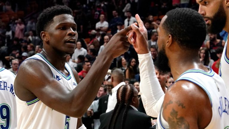 Minnesota Timberwolves guard Anthony Edwards (5) celebrates with guard Mike Conley after defeating the Miami Heat in an NBA basketball game, Monday, Dec. 18, 2023, in Miami. (AP Photo/Lynne Sladky)