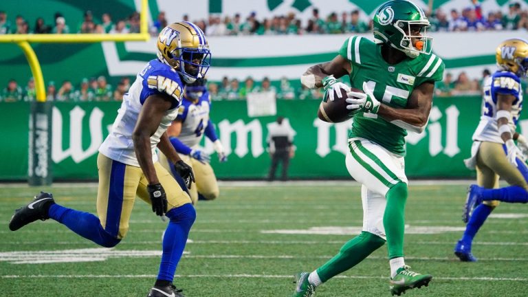 Saskatchewan Roughriders receiver Shawn Bane Jr. (15) runs the football as Winnipeg Blue Bombers defensive back Deatrick Nichols (1) runs during the second half of CFL Labour Day Classic football action in Regina, Sunday, Sept. 3, 2023. (Heywood Yu/AP)