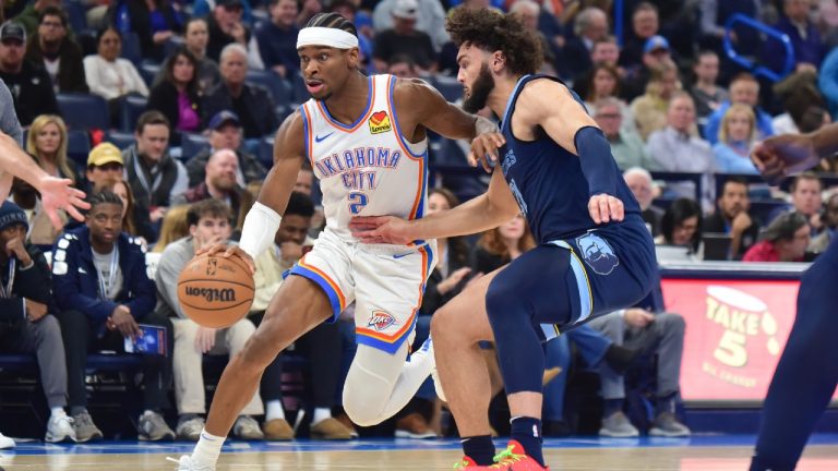 Oklahoma City Thunder guard Shai Gilgeous-Alexander, left, pushes past Memphis Grizzles forward David Roddy in the first half of an NBA basketball game, Monday, Dec. 18, 2023, in Oklahoma City. (Kyle Phillips/AP)