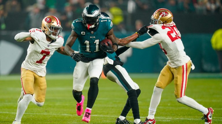 Philadelphia Eagles wide receiver A.J. Brown (11) runs with the ball after making a catch as San Francisco 49ers cornerback Charvarius Ward (7) and cornerback Ambry Thomas (20) try to stop him during the first half of an NFL football game, Sunday, Dec. 3, 2023, in Philadelphia. (Chris Szagola/AP)