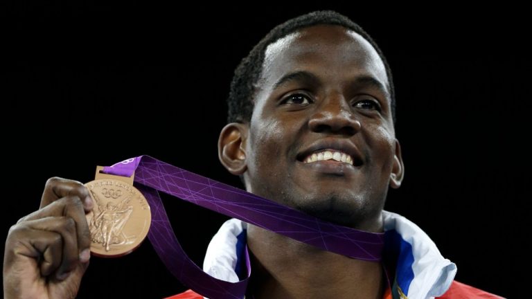 Cuba's Robelis Despaigne celebrates during the victory ceremony after winning a bronze medal in men's plus 80-kg taekwondo competition at the 2012 Summer Olympics, Saturday, Aug. 11, 2012, in London. (Ng Han Guan/ AP Photo)