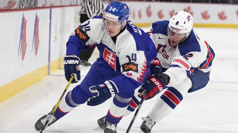 Slovakia's Adam Sykora, left, tries to get around Rutger McGroarty during first period IIHF World Junior Hockey Championship hockey action. (Ron Ward/CP)