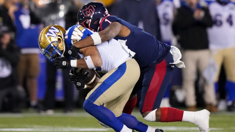 Montreal Alouettes linebacker Darnell Sankey (1) tackles Winnipeg Blue Bombers wide receiver Nic Demski (10) during the first half of the 110th CFL Grey Cup. (Nathan Denette/CP)