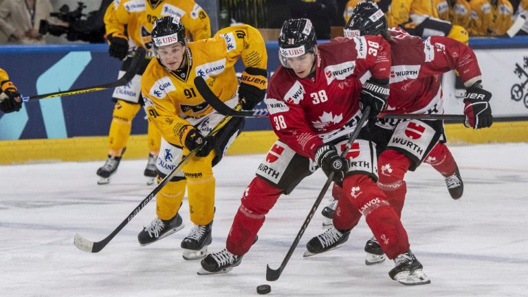 Canada's Guillaume Asselin plays against Kuopio's Oliver Kapanen during the match between Team Canada and Kalpa Kuopio of Finland at the 95th Spengler Cup ice hockey tournament in Davos, Switzerland, on Friday, Dec. 29, 2023. (Urs Flueeler/Keystone via AP)